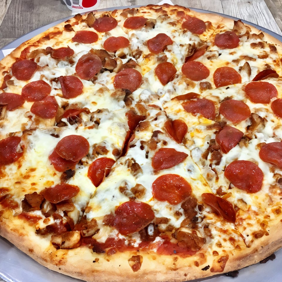 Rosella's Pizzeria's pepperoni and chicken pizza, with melted cheese and a golden crust.